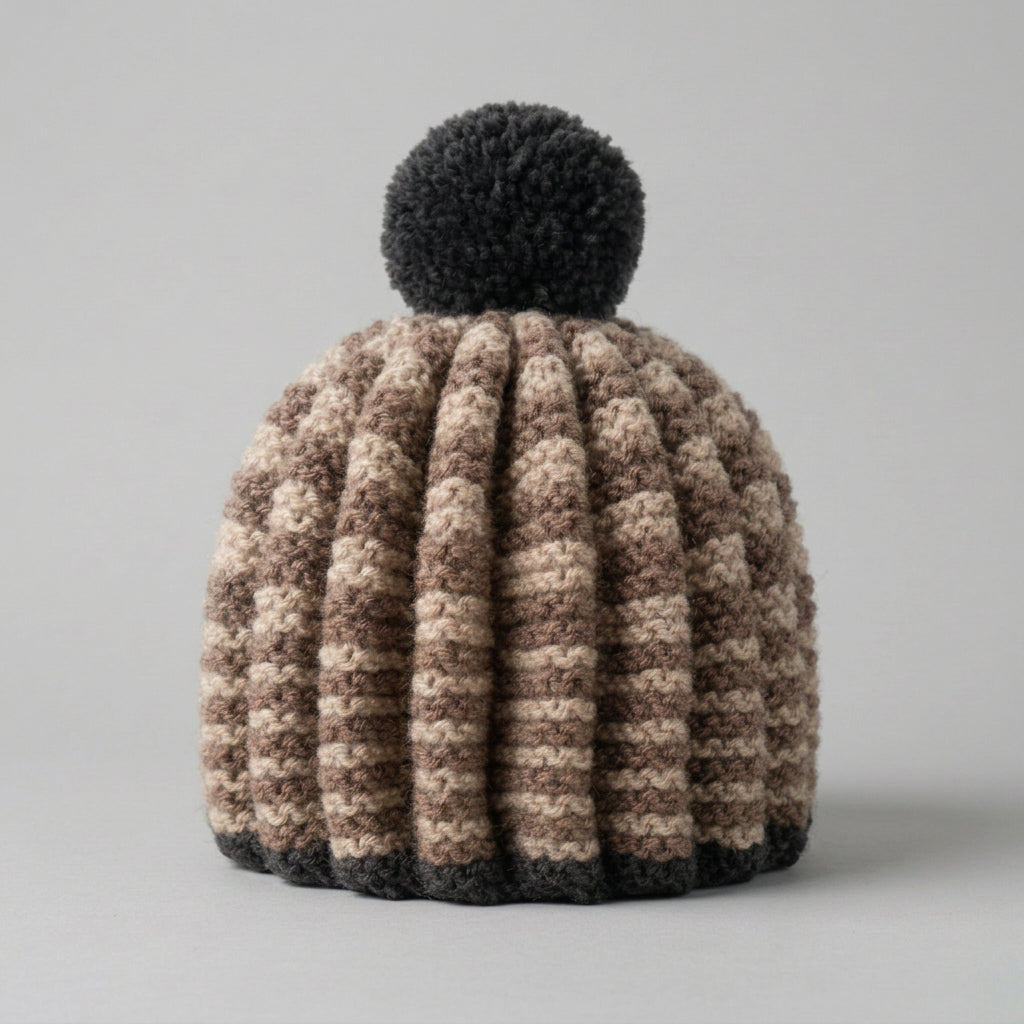A hand knitted tea cosy with pom pom